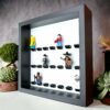 FRAMEPUNK white background display for 21 Lego minifigures, black bricks, black frame, side view, showing minifigures