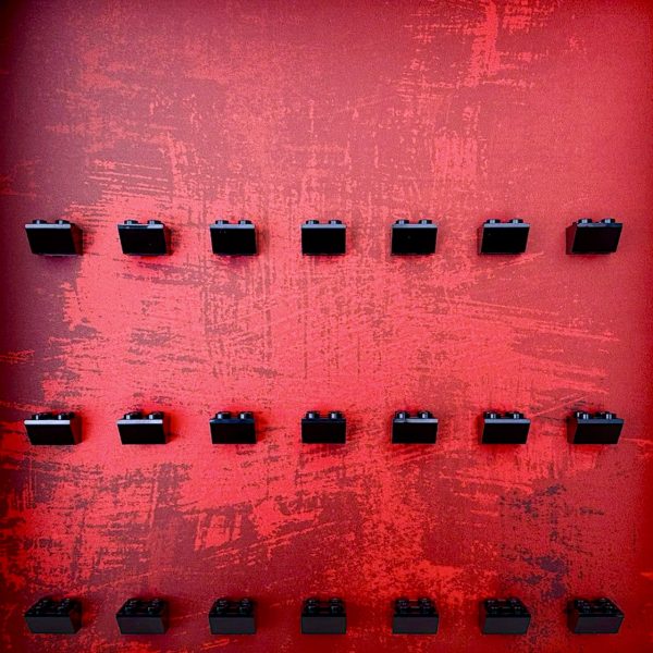 FRAMEPUNK Red Splatter LEGO minifigure display with black brick mounts. Compatible with 21 LEGO minifigures