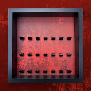 FRAMEPUNK Red Splatter LEGO minifigure display with black brick mounts. Compatible with 21 LEGO minifigures. Black case. Placed on a red splatter background