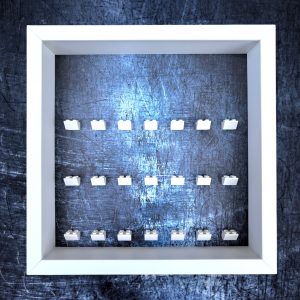 FRAMEPUNK Scratched Steel LEGO minifigure display with white brick mounts. Compatible with 21 LEGO minifigures. White case. Placed on a Steel background
