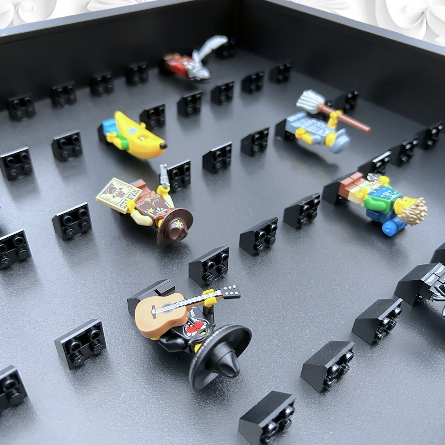 FRAMEPUNK black background and black mounts display frame compatible with 50 Lego minifigures (black) Depth view - demonstrating how minifgures look